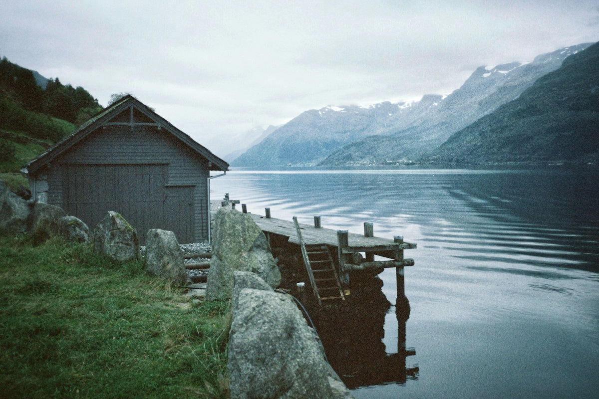 gray wooden house near lake