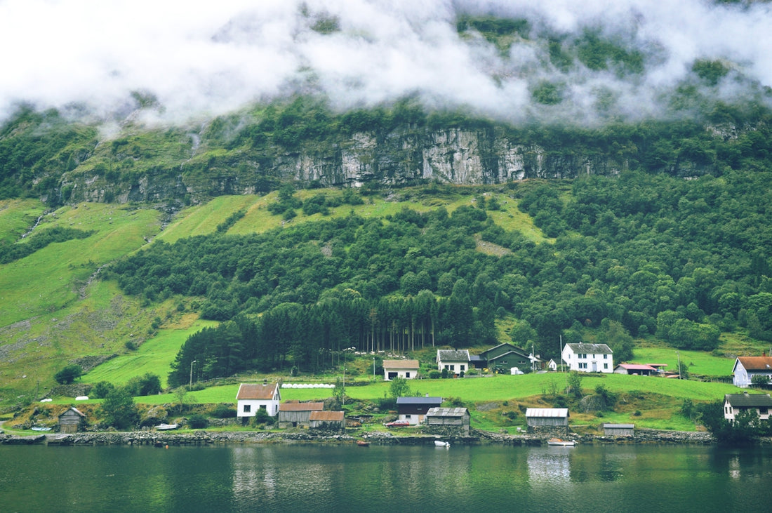 green mountain near body of water during daytime