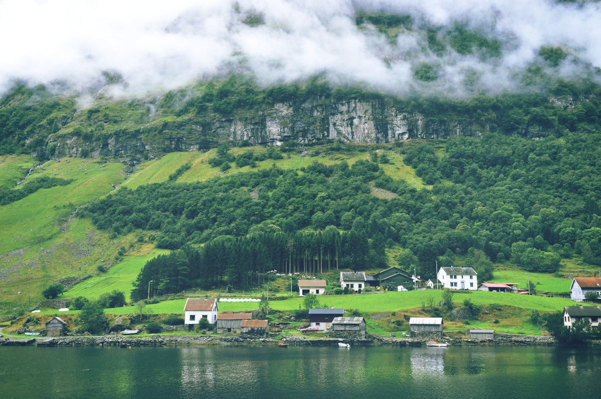 green mountain near body of water during daytime