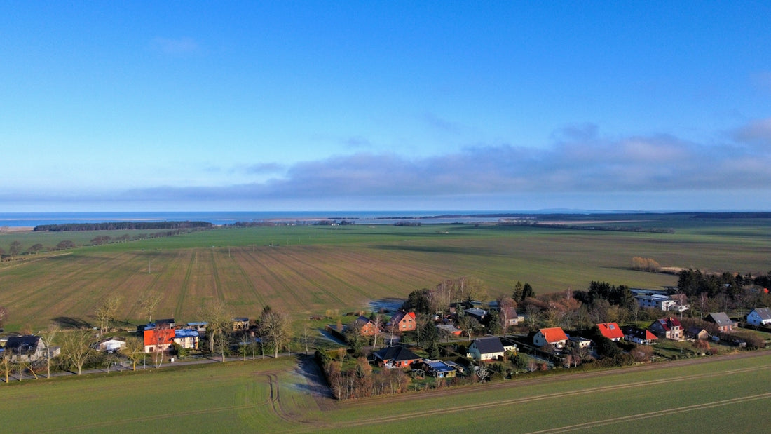 an aerial view of a rural area with houses and fields