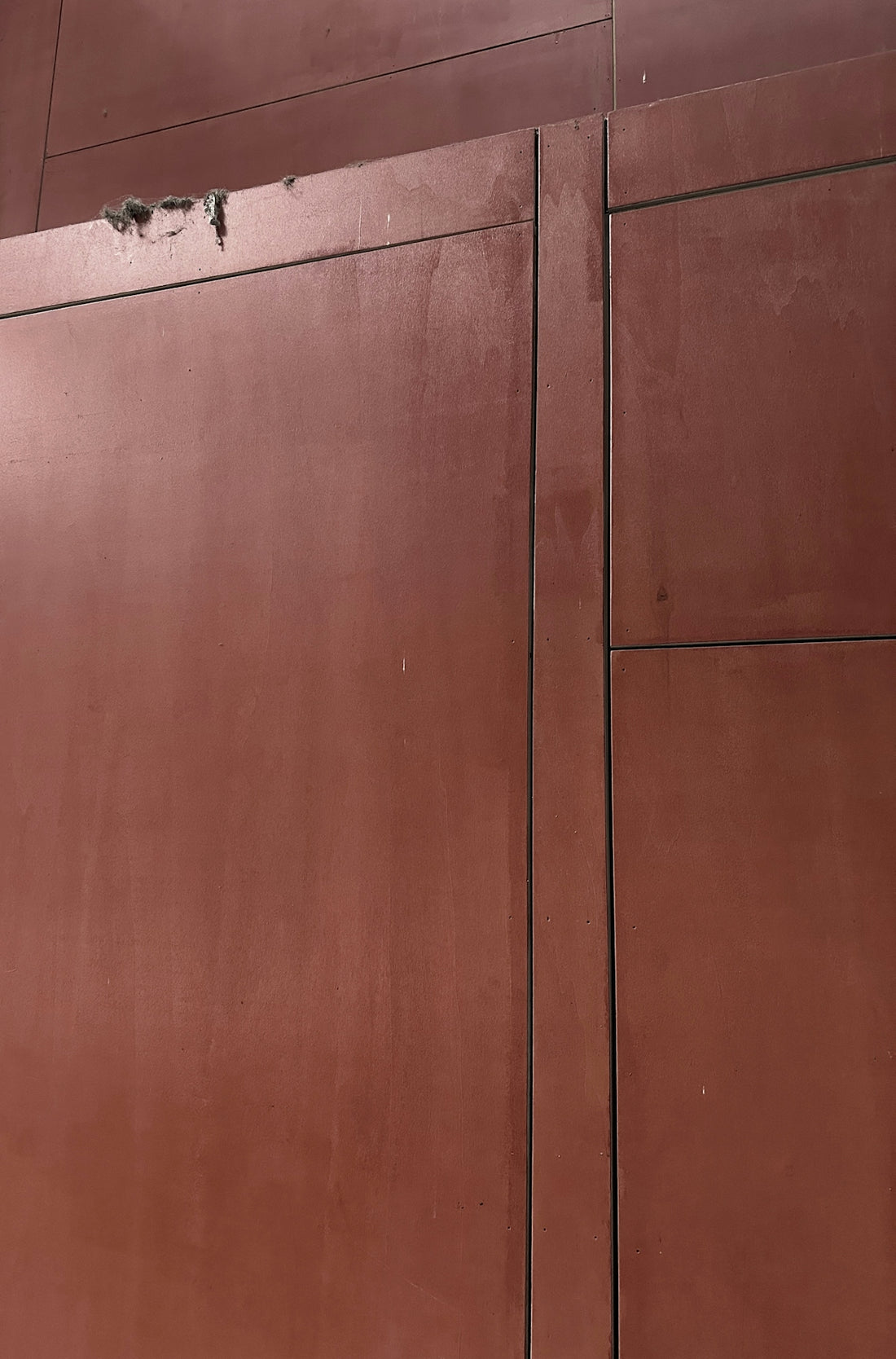 a red building with a clock on the side of it