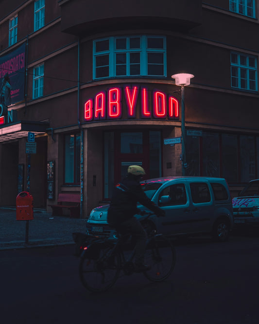 The babylon theater glows red at night.