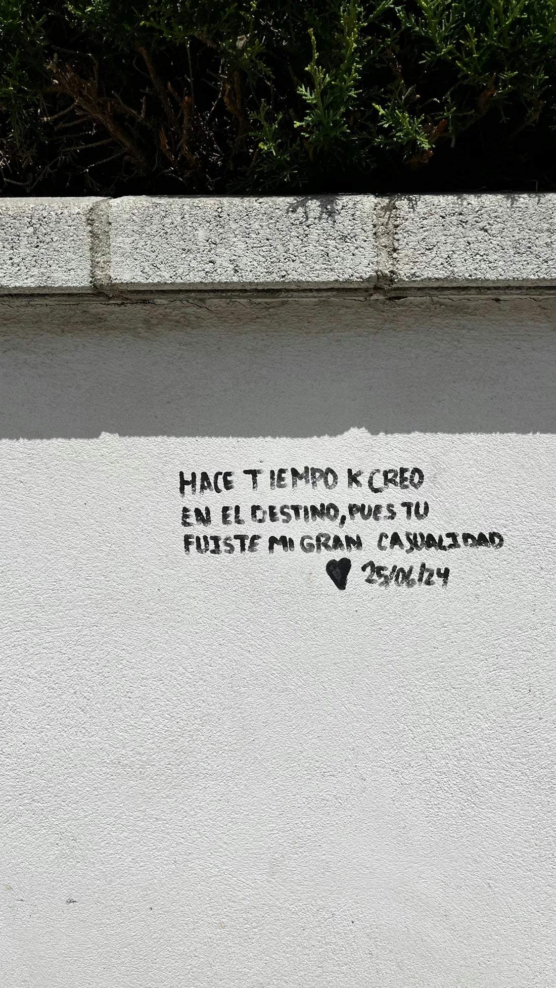Graffiti on a wall reads hace tiempo k creo en el destino, pues tu fuiste mi gran casualidad