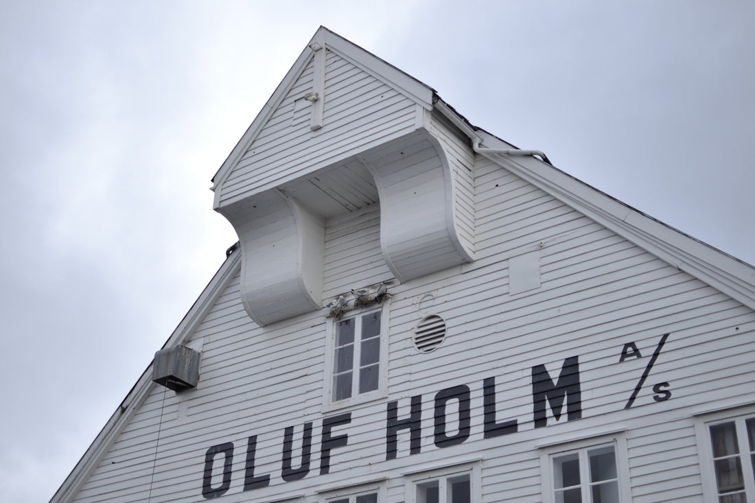 White building with oluf holm lettering