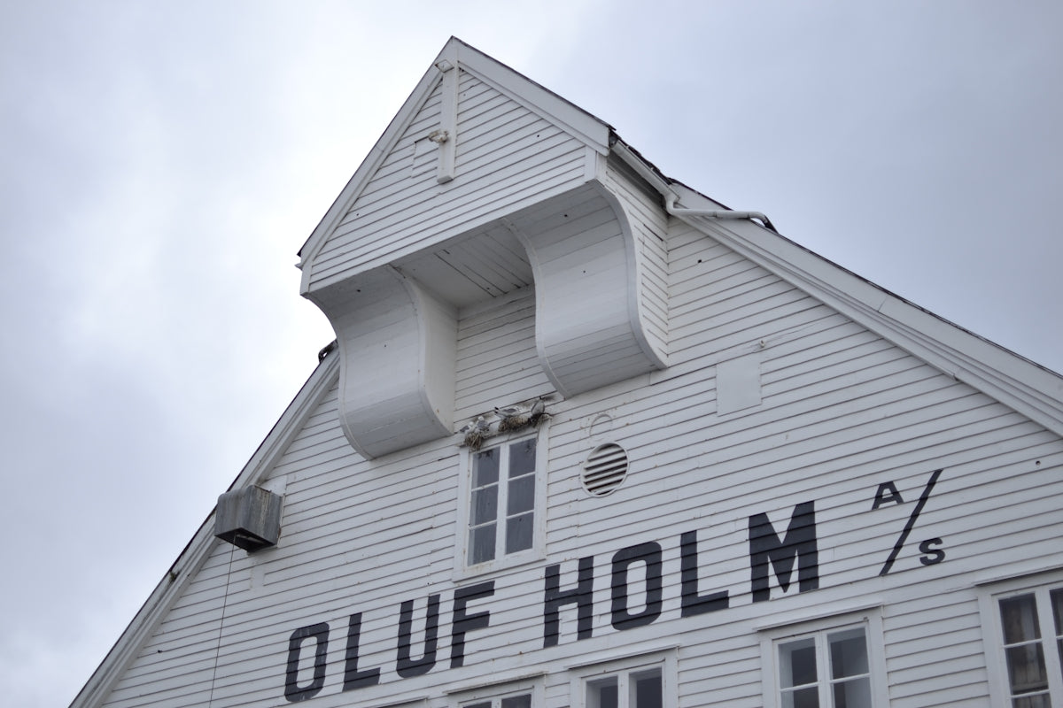 White building with oluf holm lettering