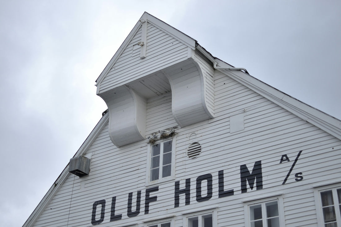 White building with oluf holm lettering
